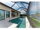 Long shot of the pool with screened in enclosure with seating area at 1492 Aqui Esta Dr, Punta Gorda, FL 33950