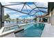 Inviting waterfront pool and spa with screened enclosure and boat dock at 1492 Aqui Esta Dr, Punta Gorda, FL 33950