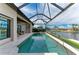 Sparkling pool and spa with screened enclosure and waterfront access at 1492 Aqui Esta Dr, Punta Gorda, FL 33950
