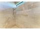 Walk in shower featuring marble walls and a glass enclosure, and a rainfall shower head at 1492 Aqui Esta Dr, Punta Gorda, FL 33950