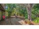 Private backyard with mature trees and a wooden deck at 1525 Hinton St, Port Charlotte, FL 33952
