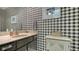 Stylish half bathroom featuring black and white checkered wallpaper, a vanity with an oval sink at 1525 Hinton St, Port Charlotte, FL 33952