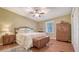 Cozy bedroom with a ceiling fan, wood floors, bed, dresser, and a window with natural light at 1525 Hinton St, Port Charlotte, FL 33952