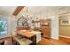 Charming dining room featuring a wooden table with bench seating, chandelier, and a large wooden cabinet at 1525 Hinton St, Port Charlotte, FL 33952