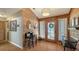 Welcoming entryway with wood-paneled walls, decorative mirror, and light-filled, leaded-glass front door at 1525 Hinton St, Port Charlotte, FL 33952