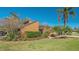 The front exterior features a charming tan home with lush landscaping and mature palm trees at 1525 Hinton St, Port Charlotte, FL 33952