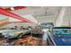 Spacious garage featuring multiple classic cars, epoxy flooring, and an electric door at 1525 Hinton St, Port Charlotte, FL 33952
