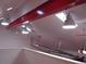 Garage ceiling featuring beams, lighting, ceiling fans, and two electric garage door openers at 1525 Hinton St, Port Charlotte, FL 33952