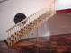 Wood stairs going up to a loft in the garage at 1525 Hinton St, Port Charlotte, FL 33952