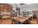 Large kitchen island with seating, modern appliances, and wooden walls creating a warm and inviting atmosphere at 1525 Hinton St, Port Charlotte, FL 33952