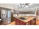 Spacious kitchen with ample cabinet space, a large island, and stainless steel refrigerator at 1525 Hinton St, Port Charlotte, FL 33952