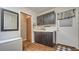 Functional laundry area with stylish cabinets, a folding table, and a mirror at 1525 Hinton St, Port Charlotte, FL 33952