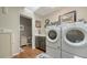 Laundry room with a washer, dryer, stylish finishes and a skylight for plenty of natural light at 1525 Hinton St, Port Charlotte, FL 33952