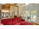 Cozy living room featuring wood accents, a comfortable red sofa, and access to a bright office space at 1525 Hinton St, Port Charlotte, FL 33952