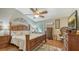 Comfortable main bedroom with a ceiling fan, wood floors, ornate wooden furniture and accents and wall art at 1525 Hinton St, Port Charlotte, FL 33952