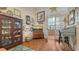 Cozy office space with wood floors, ample decor, an antique desk, and a view to another room at 1525 Hinton St, Port Charlotte, FL 33952