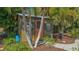 Charming shed surrounded by lush greenery and tropical palm trees, perfect for outdoor storage and relaxation at 1525 Hinton St, Port Charlotte, FL 33952