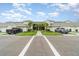 Modern condo building featuring well-manicured lawns, garages and beautiful landscaping at 16000 Grassland Ln # 3116, Punta Gorda, FL 33982