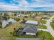 Expansive aerial view of neighborhood homes, ponds, and landscaped yards with screened-in pools in a lush community at 16265 Juarez Cir, Punta Gorda, FL 33955