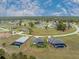 Aerial view of a single-Gathering home with screened-in pool and a spacious yard in a quiet neighborhood at 16265 Juarez Cir, Punta Gorda, FL 33955