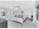 Spacious bedroom featuring a large bed, soft carpeting, and natural light from the window at 16265 Juarez Cir, Punta Gorda, FL 33955