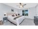 Bright bedroom with a ceiling fan, neutral walls, and a large window, creating a relaxing space at 16265 Juarez Cir, Punta Gorda, FL 33955