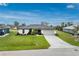 Beautifully landscaped one story home with a paver driveway and a two car garage at 16265 Juarez Cir, Punta Gorda, FL 33955