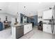 Open-concept kitchen with modern appliances, granite countertops, a large island with seating, seamlessly connecting to the dining area at 16265 Juarez Cir, Punta Gorda, FL 33955