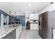 Modern kitchen island with granite countertops, stainless steel appliances, and adjacent dining area at 16265 Juarez Cir, Punta Gorda, FL 33955