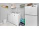 Well-lit laundry room with a washer and dryer and storage space for household essentials at 16265 Juarez Cir, Punta Gorda, FL 33955