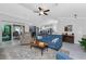 Bright and airy living room with vaulted ceilings, ceiling fan and access to the lanai at 16265 Juarez Cir, Punta Gorda, FL 33955