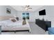 Bright main bedroom with a ceiling fan, gray walls, a dresser, and an outside view at 16265 Juarez Cir, Punta Gorda, FL 33955