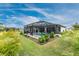 Screened-in pool with lush landscaping creating a private backyard oasis at 16265 Juarez Cir, Punta Gorda, FL 33955