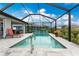 Screened-in pool featuring a lounge chair, pavers, a metal fence, plants, and open access to the yard at 16265 Juarez Cir, Punta Gorda, FL 33955