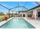 Screened-in pool featuring a lounge chair, pavers, a metal fence, plants, and open access to the yard at 16265 Juarez Cir, Punta Gorda, FL 33955