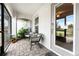 Cozy screened-in porch with comfortable seating and decorative plants, creating a relaxing outdoor space for enjoying the fresh air at 16265 Juarez Cir, Punta Gorda, FL 33955