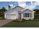 Charming single-story home featuring a two-car garage, well-manicured lawn, and beautifully landscaped front yard at 16395 Larocha Dr, Punta Gorda, FL 33955
