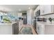 Modern kitchen with white cabinetry, stainless steel appliances, and a spacious island, ideal for cooking at 16395 Larocha Dr, Punta Gorda, FL 33955