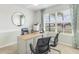 Well-lit home office with a large window, contemporary desk, and comfortable seating, perfect for productivity at 16395 Larocha Dr, Punta Gorda, FL 33955