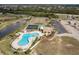 Aerial view showcasing community pool, tennis courts, and manicured landscaping at 175 Kings Hwy # 538, Punta Gorda, FL 33983