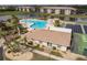 Aerial view of a community pool, tennis courts, and clubhouse surrounded by lush landscaping at 175 Kings Hwy # 538, Punta Gorda, FL 33983
