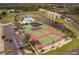 Aerial view showcases community pool, tennis courts, and well-manicured landscaping at 175 Kings Hwy # 538, Punta Gorda, FL 33983