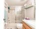 Bathroom featuring a glass shower door, white vanity and well-lit mirror and wall decor at 175 Kings Hwy # 538, Punta Gorda, FL 33983