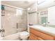 Bathroom with a glass shower door, wood vanity and coordinated towel and shelf decor at 175 Kings Hwy # 538, Punta Gorda, FL 33983