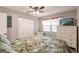 Inviting bedroom featuring a floral comforter, ceiling fan, and a window with television for relaxation at 175 Kings Hwy # 538, Punta Gorda, FL 33983
