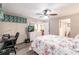 Bright bedroom with a desk, bed and a white dresser, gray flooring and walk through to bathroom at 175 Kings Hwy # 538, Punta Gorda, FL 33983