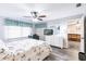 Bright bedroom with a bed and a white dresser and gray flooring with walk through to living area at 175 Kings Hwy # 538, Punta Gorda, FL 33983