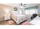 Cozy bedroom with floral bedding, two nightstands, and a ceiling fan with decorative wreath at 175 Kings Hwy # 538, Punta Gorda, FL 33983
