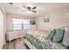 Bright bedroom featuring a floral comforter, ceiling fan and a window with light-filtering blinds at 175 Kings Hwy # 538, Punta Gorda, FL 33983