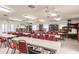 Multi-purpose room with rows of tables, chairs, and bookshelves at 175 Kings Hwy # 538, Punta Gorda, FL 33983
